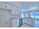 Well-lit kitchen boasts white cabinetry, stainless steel appliances, and granite countertops at 4062 Tullamore Ln, Auburndale, FL 33823