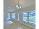 Bright living room featuring tile floors, modern lighting, and large windows with a view to the outside at 4062 Tullamore Ln, Auburndale, FL 33823