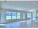 Bright living room with tile floors, recessed lighting and large windows offering plenty of natural light at 4062 Tullamore Ln, Auburndale, FL 33823