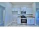 Modern kitchen featuring stainless steel appliances and white cabinets at 4066 Tullamore Ln, Auburndale, FL 33823