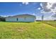 The rear of the property with a spacious yard, with a view of the wetland conservation area at 4123 Tullamore Ln, Auburndale, FL 33823