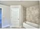 Bright bathroom with a tiled shower and tub combination, perfect for relaxation at 4123 Tullamore Ln, Auburndale, FL 33823