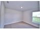 This cozy bedroom is carpeted, has natural light from the window, and is freshly painted at 4123 Tullamore Ln, Auburndale, FL 33823