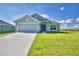 Inviting single-story home featuring a two-car garage, manicured lawn, and a charming front entryway at 4123 Tullamore Ln, Auburndale, FL 33823