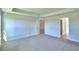 Spacious carpeted bedroom with tray ceiling and neutral walls provides a calming retreat at 4123 Tullamore Ln, Auburndale, FL 33823