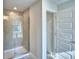 Modern bathroom with a glass-enclosed shower and tiled walls, complemented by contemporary fixtures at 4123 Tullamore Ln, Auburndale, FL 33823