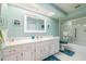 Bright bathroom featuring white vanity cabinets and a shower-tub combo at 4315 Larrys Lagoon, Winter Haven, FL 33884