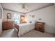 Cozy bedroom showcasing wooden furniture, decorative wallpaper, and natural light at 4315 Larrys Lagoon, Winter Haven, FL 33884