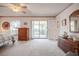 Well-lit bedroom with sliding door access to the lanai and neutral color scheme at 4315 Larrys Lagoon, Winter Haven, FL 33884