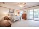 Cozy bedroom featuring a ceiling fan, backyard views, and decorative wall art at 4315 Larrys Lagoon, Winter Haven, FL 33884