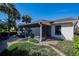 Exterior showcasing a screened patio area surrounded by lush landscaping at 4315 Larrys Lagoon, Winter Haven, FL 33884
