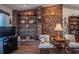 Unique living room featuring a brick accent wall with decorative shelving and display items at 4315 Larrys Lagoon, Winter Haven, FL 33884