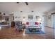 Cozy living room with a vaulted ceiling, wood laminate flooring, and comfortable seating arrangement at 4315 Larrys Lagoon, Winter Haven, FL 33884