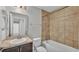 Bathroom featuring a single sink vanity and a tub with brown tile surround at 4424 Reding Way, Lakeland, FL 33813