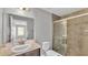 Bathroom featuring a single sink vanity and a glass enclosed shower with brown tile at 4424 Reding Way, Lakeland, FL 33813