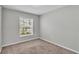 Bedroom with neutral walls and carpet, featuring a window with natural light at 4424 Reding Way, Lakeland, FL 33813