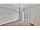 Dining area featuring neutral walls, wood floors, and sliding glass door to the backyard at 4424 Reding Way, Lakeland, FL 33813
