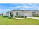 Single-story home featuring a well-manicured lawn, a two-car garage, and neutral exterior paint at 4424 Reding Way, Lakeland, FL 33813