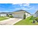 Single story home with a two-car garage and well maintained lawn, landscaping, and neutral paint at 4424 Reding Way, Lakeland, FL 33813