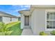 The exterior front door, featuring neutral paint color and hardware at 4424 Reding Way, Lakeland, FL 33813