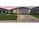 Charming single-story home featuring a well-manicured lawn and an attached two-car garage at 4424 Reding Way, Lakeland, FL 33813