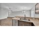 Bright kitchen featuring stone countertops, stainless steel appliances, and an open concept design at 4424 Reding Way, Lakeland, FL 33813
