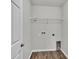 Laundry room featuring gray walls and wood-look floors at 4424 Reding Way, Lakeland, FL 33813