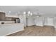Open concept living room with hardwood floors and modern chandelier at 4424 Reding Way, Lakeland, FL 33813