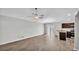Open concept living room showcasing hardwood floors, modern lighting, and seamless kitchen access at 4424 Reding Way, Lakeland, FL 33813