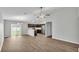 Open concept living room with hardwood floors and stainless steel appliances in the kitchen at 4424 Reding Way, Lakeland, FL 33813