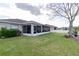 A spacious yard featuring a screened-in porch and well-manicured lawn at 4427 Whistlewood Cir, Lakeland, FL 33811
