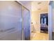 The bathroom features a glass enclosed shower and is attached to a light and airy main bedroom at 4427 Whistlewood Cir, Lakeland, FL 33811