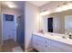 The well-lit bathroom offers a double vanity, glass-enclosed shower, and access to a walk-in closet at 4427 Whistlewood Cir, Lakeland, FL 33811