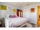 Bedroom showcasing ample space, complemented by a wooden armoire, a white bed, and light-colored walls at 4427 Whistlewood Cir, Lakeland, FL 33811