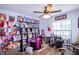 Unique bedroom with a vast collection of collectible dolls, display shelves, and a ceiling fan at 4427 Whistlewood Cir, Lakeland, FL 33811