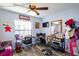 Bedroom featuring wood-look floors, a ceiling fan, and a table and mirror used as vanity space at 4427 Whistlewood Cir, Lakeland, FL 33811
