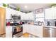 Charming kitchen with white cabinets, stainless steel appliances, and modern countertops at 4427 Whistlewood Cir, Lakeland, FL 33811