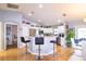 Open kitchen with counter seating, white cabinets, stainless steel appliances, and backyard access at 4427 Whistlewood Cir, Lakeland, FL 33811