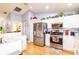 Well-lit kitchen features white cabinets, stainless steel appliances, and modern backsplash at 4427 Whistlewood Cir, Lakeland, FL 33811
