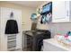 Modern laundry room equipped with high-efficiency washer/dryer, storage shelves, and essential amenities at 4427 Whistlewood Cir, Lakeland, FL 33811