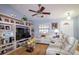 Inviting living room featuring a TV, built-in shelving, and stylish decor at 4427 Whistlewood Cir, Lakeland, FL 33811