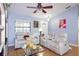 Living room with comfortable seating, a ceiling fan, and abundant natural light at 4427 Whistlewood Cir, Lakeland, FL 33811