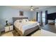 Relaxing main bedroom features a plush bed, modern nightstands, and a ceiling fan for ultimate comfort at 4427 Whistlewood Cir, Lakeland, FL 33811