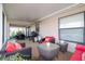 A covered patio featuring comfortable seating, a grill, and outdoor dining, perfect for relaxing and entertaining at 4427 Whistlewood Cir, Lakeland, FL 33811