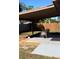 Backyard featuring a covered patio with seating area, complemented by a well-maintained lawn and wooden fence at 4641 Devon Ave, Lakeland, FL 33813
