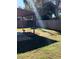 Lush backyard featuring a spacious lawn, mature trees, and a sturdy wooden fence at 4641 Devon Ave, Lakeland, FL 33813