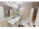 Spacious bathroom featuring a shower/tub combo, double vanity, and bright lighting at 4641 Devon Ave, Lakeland, FL 33813