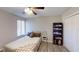 Cozy bedroom with a ceiling fan, natural light, and shoe storage shelves at 4641 Devon Ave, Lakeland, FL 33813