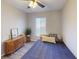 Cozy bedroom features a bed with plush pillows and a wooden cabinet, illuminated by a ceiling fan at 4641 Devon Ave, Lakeland, FL 33813