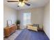 Charming bedroom featuring cozy bed with accent pillows, light-filled window, and stylish wooden dresser at 4641 Devon Ave, Lakeland, FL 33813